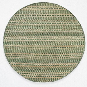 May include: A round green and natural woven rug with a striped pattern.