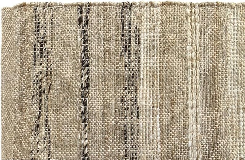 Detailed view of the intricate handwoven pattern and texture of the eco-friendly jute rug, showcasing its craftsmanship