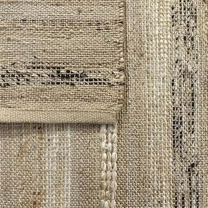 Close-up of the handwoven texture and natural tones of an eco-friendly jute rug.