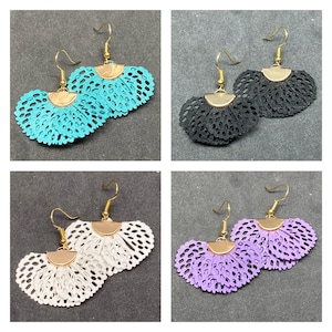 May include: Four pairs of earrings with a fan-shaped design. The earrings are made of a delicate lace material and come in four colors: turquoise, black, white, and purple.