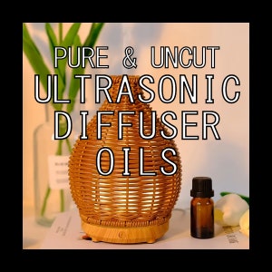 May include: A brown wicker ultrasonic diffuser with a wooden base and a small bottle of essential oil. The diffuser has a light on the bottom and the text "PURE & UNCUT ULTRASONIC DIFFUSER OILS" is written in white on a light background.