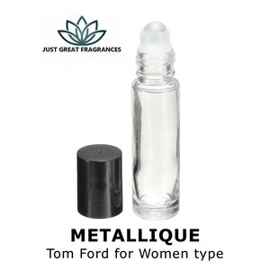 May include: A clear glass roll-on bottle with a black cap. The bottle is filled with a clear liquid. The text "METALLIQUE Tom Ford for Women type" is printed below the bottle.