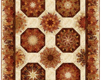 May include: A quilt with a cream background and eight octagonal brown and orange patterned blocks. The blocks are arranged in a grid pattern and are surrounded by a brown border with a leafy pattern.