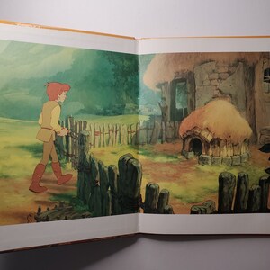 May include: Illustration from a children's book depicting a young person in tan clothing walking through a wooden gate. A small stone cottage with a thatched roof and a dog house are in the background. The scene is set in a grassy field with a forest in the distance.