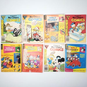 May include: A collection of eight vintage Walt Disney Comics Digests. The comic books feature colorful covers with classic Disney characters like Donald Duck, Mickey Mouse, and Goofy. The comics are in various conditions, with some showing signs of wear.