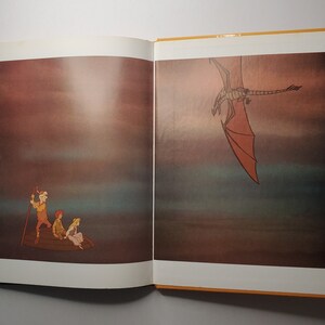 May include: An open book illustration featuring a boat with three people and a dragon in the sky. The dragon has red wings and is flying in a dark, atmospheric setting. The boat is brown, and the people are wearing various outfits.