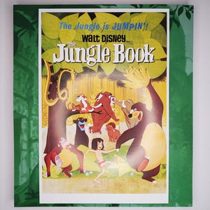 May include: A vintage poster for Disney's "The Jungle Book" featuring a colorful illustration of Baloo, Bagheera, Mowgli, and other characters. The poster has the text "The Jungle is Jumpin'!" and "Walt Disney" at the top.