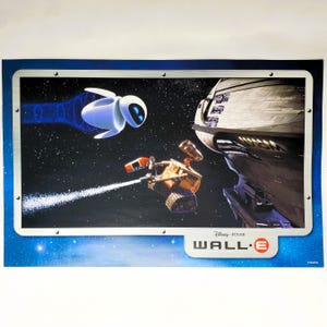 May include: A rectangular poster featuring the characters WALL-E and EVE in space. WALL-E is a small, rusty robot emitting a white trail, while the sleek, white EVE robot flies nearby. A large spaceship is visible on the right. The text WALL-E is present.