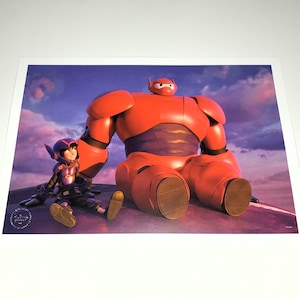 May include: A print featuring Baymax and Hiro from Big Hero 6. Baymax, a large red inflatable robot, sits next to Hiro, who wears a purple and black suit. The background shows a sunset with purple and blue hues.