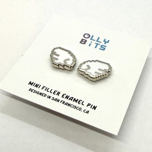 May include: Two pixelated cloud-shaped mini filler enamel pins with a white center and silver outline, displayed on a white card. The card features the text "Olly Bits" and "Mini Filler Enamel Pin Designed in San Francisco, CA."