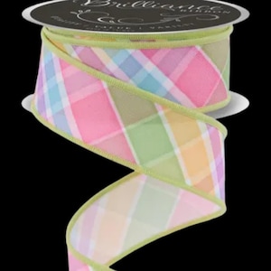 May include: A spool of decorative ribbon with a pastel plaid pattern in pink, blue, green, and yellow. The ribbon has a light green border and is labeled "Brilliance Ribbon". The ribbon is ideal for crafts and gift wrapping.