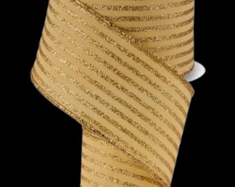 May include: A spool of gold ribbon with glitter stripes. The ribbon is a light tan color with diagonal stripes of gold glitter. The ribbon is likely used for crafts, gift wrapping, or decorations.