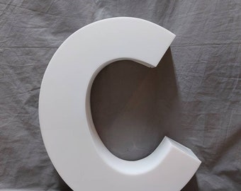 Vintage illuminated letter "c" neon sign
