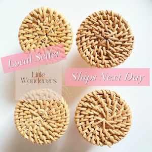May include: Four round woven wicker coasters in a natural beige color. The coasters are arranged in a square pattern on a white background. The text "Local Seller" and "Ships Next Day" is visible in the image.