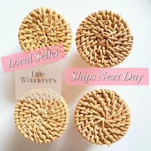 May include: Four round woven wicker coasters in a natural beige color. The coasters are arranged in a square pattern on a white background. The text "Local Seller" and "Ships Next Day" is visible in the image.