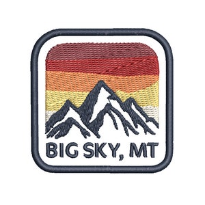 May include: A white embroidered patch with a blue outline. The patch features a mountain range with a sunset behind it. The text "BIG SKY, MT" is below the mountains.