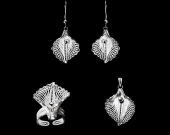 May include: A set of silver filigree jewellery featuring a ring, a pendant, and a pair of earrings. Each piece is intricately designed with a delicate floral pattern and a small pearl accent.