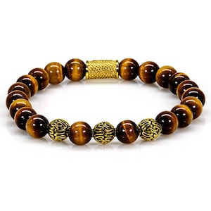 May include: A brown and gold beaded bracelet with a gold metal clasp. The beads are round and have a tiger's eye pattern.