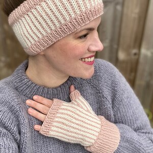 May include: Pink and white striped knit headband and fingerless gloves. The headband is wide and covers the ears. The gloves are fingerless and have a pink cuff.