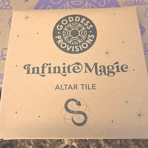 May include: A brown cardboard box with a black and white logo that says "Goddess Provisions" and "Infinite Magic." The box also has a black and white image of a snake and the text "Altar Tile."