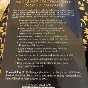 May include: A paperback book titled "Call on the Power of the Saints for Practical Help in Your Daily Life." The cover features text about spiritual allies, rituals, and divination. The author is Reverend Ray T. Malbrough.
