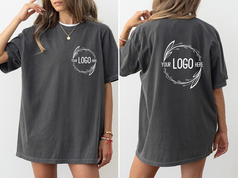 May include: A charcoal gray oversized t-shirt with a white floral design and the text "YOUR LOGO HERE" on the front and back.