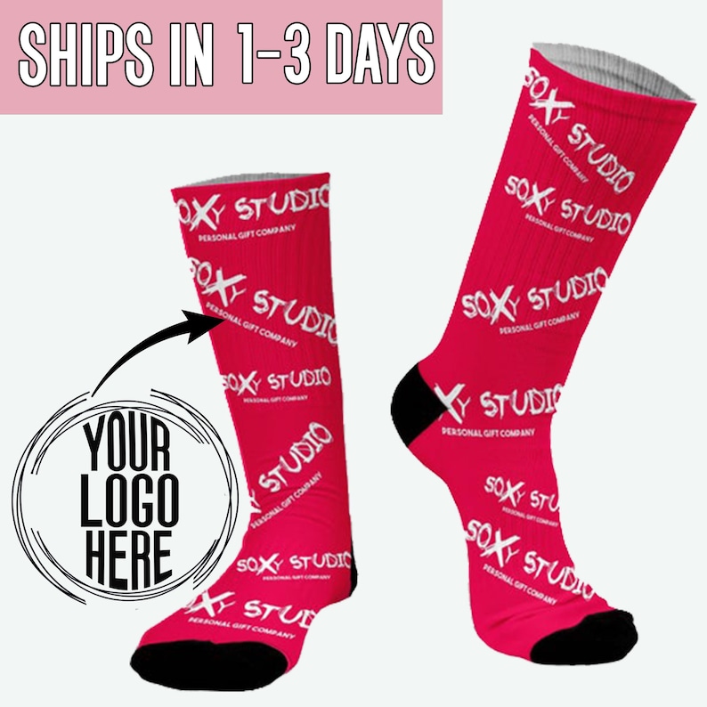 May include: A pair of pink socks with a white "SOXY STUDIO" logo repeated on the fabric. The socks have a black toe and heel. A white circle with the text "YOUR LOGO HERE" is in the image.