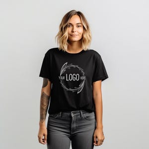 May include: A black t-shirt with a white floral design and the text "YOUR LOGO HERE" in the center.