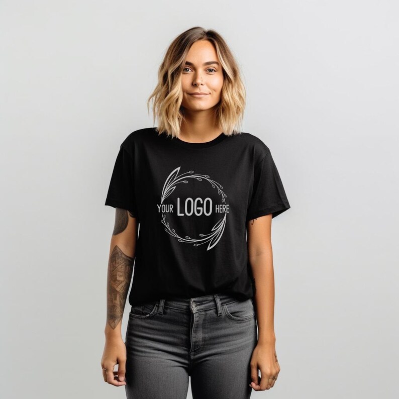 May include: A black t-shirt with a white floral design and the text "YOUR LOGO HERE" in the center.