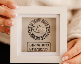 A 'Tin Anniversary' 10 years frame with tin heart design