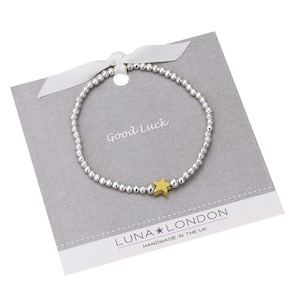 Porte-bonheur - Bracelet extensible en forme d'étoile dorée sur une carte-cadeau avec zone de message imprimée
