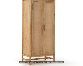 May include: A tall, light-toned wooden wardrobe featuring two doors with woven cane panels and vertical wooden handles. The cabinet stands on a raised frame base and includes the text DESIGNED & MANUFACTURED BY KIDSWOODSTORE.COM.
