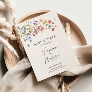 May include: Save the date card with watercolor floral design. The card features a floral border with pink, yellow, and blue flowers. The text reads "Save the Date for the wedding of Jessica and Richard, Sept 14th, 2021, Anywhere City, CA. Formal invitation to follow."