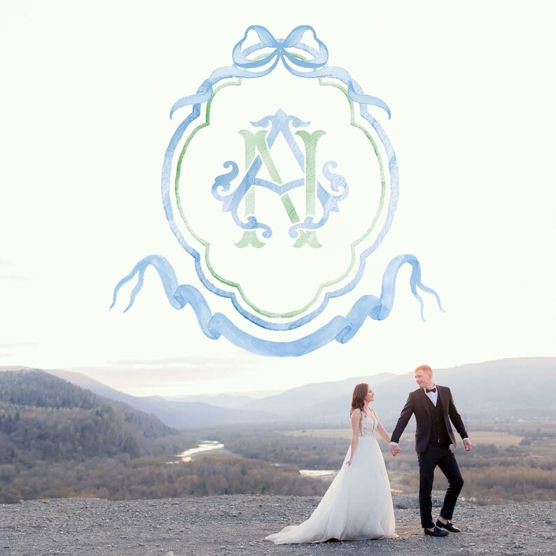 May include: A watercolor wedding monogram with a blue and green color scheme. The monogram features the letters "A" and "N" intertwined. The monogram is surrounded by a blue ribbon with a bow at the top. A couple is standing in the background, holding hands and looking at each other.