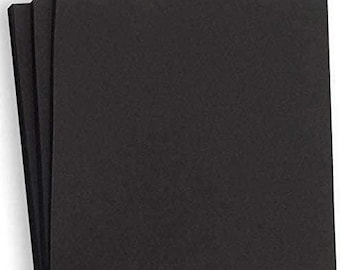 May include: A stack of black cardstock paper. The paper is smooth and has a subtle texture.