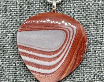 Brick red and white banded Wonderstone triangle pendant necklace on silver