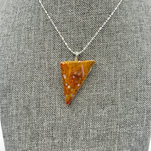 May include: A silver chain necklace with a triangular pendant made of orange, white, and brown agate.