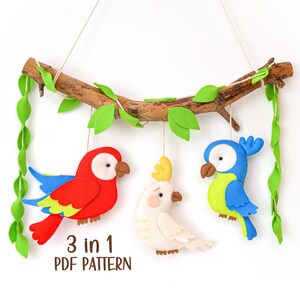May include: A 3 in 1 PDF pattern for sewing a felt parrot, cockatoo, and bluebird hanging mobile. The birds are hanging from a branch with green felt leaves.