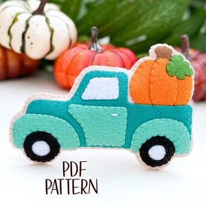 May include: A teal felt truck with a white cab and black wheels carrying a felt orange pumpkin. The truck is a felt applique pattern for a craft project.  PDF PATTERN.
