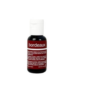 May include: A small, cylindrical bottle of Bordeaux-colored food coloring with a white screw-top cap. The label features the word 'bordeaux' in white text, followed by a list of ingredients in English, Spanish, and French, with a net weight of 0.70 oz.