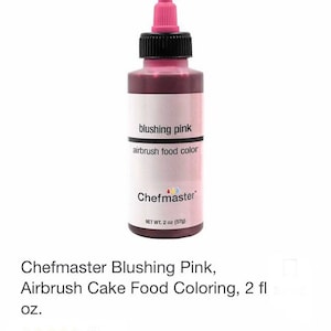 May include: A bottle of Chefmaster Blushing Pink airbrush food color. The bottle has a pink nozzle and a black cap. The label reads "blushing pink" and "airbrush food color". The bottle contains 2 oz (57g) of product.