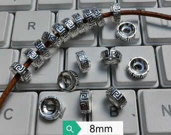 May include: Silver-toned metal beads with a geometric design. The beads are 8mm in diameter and are arranged on a keyboard.