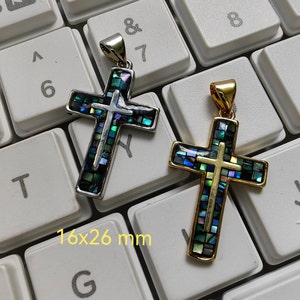 Könnte beinhalten: Zwei silberne und goldene Kreuzanhänger mit einem Mosaik aus schillerndem Blau, Grün und Gold. Die Kreuze sind 16x26 mm groß.