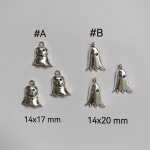 May include: Two sizes of silver ghost charms with a hole for hanging. The smaller charm is 14x17 mm and the larger charm is 14x20 mm.