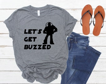 May include: Gray t-shirt with a black silhouette of Buzz Lightyear from Toy Story and the text "Let's Get Buzzed".