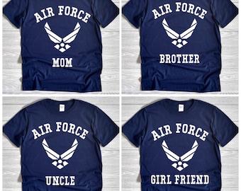 May include: Four navy blue t-shirts with white text and graphics. Each shirt has the words "AIR FORCE" above a stylized emblem. Below the emblem, the shirts read "MOM", "BROTHER", "UNCLE", and "GIRL FRIEND".
