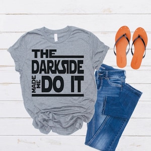 May include: Gray t-shirt with black text that reads "The Darkside Made Me Do It".
