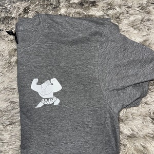May include: A heather grey t-shirt featuring a white graphic of a cartoon character flexing its muscles.