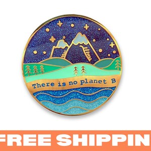 May include: Gold-toned enamel pin with a blue, green, and white mountain scene with stars and the text "There is no planet B".
