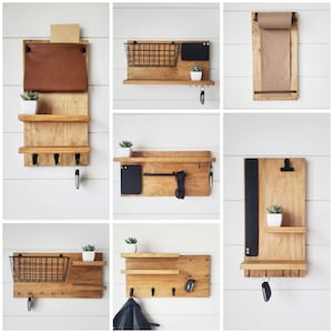 May include: A set of six wooden wall organizers with different configurations. Each organizer features a shelf, hooks, and a small black board or wire basket. Some organizers include a small plant or a roll of paper.
